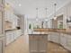 Kitchen island with granite countertops and white cabinets at 9117 Monarchos Ct, Waxhaw, NC 28173