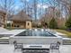 Tranquil pool with water feature and fire pit at 9117 Monarchos Ct, Waxhaw, NC 28173