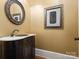 Elegant powder room with a dark vanity and marble countertop at 9117 Monarchos Ct, Waxhaw, NC 28173