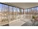 Covered back deck with gray flooring and white railing overlooking a tree-filled backyard at 926 Lone Oak Ln, Mooresville, NC 28115