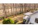 Aerial view of a home's back exterior with a wooden deck overlooking a spacious, wooded backyard at 926 Lone Oak Ln, Mooresville, NC 28115