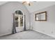 An unfurnished bedroom features a vaulted ceiling, window, and vintage mirror at 926 Lone Oak Ln, Mooresville, NC 28115