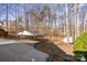 View of a driveway, carport, and wooded backyard at 926 Lone Oak Ln, Mooresville, NC 28115