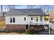 Back exterior of a two-story home showing a brick foundation and back deck with access to the yard at 926 Lone Oak Ln, Mooresville, NC 28115