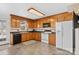 This eat-in kitchen features wood cabinetry, and white appliances at 926 Lone Oak Ln, Mooresville, NC 28115