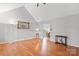 Bright, open living room boasts vaulted ceilings, hardwood floors, and a cozy ambiance at 926 Lone Oak Ln, Mooresville, NC 28115