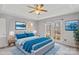 This staged bedroom is bright, with blue bedding and a large window at 926 Lone Oak Ln, Mooresville, NC 28115