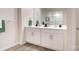 Double vanity bathroom with white cabinets and wood-look floors at 1020 20Th Avenue Se Way, Hickory, NC 28602