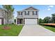 Two-story house with gray siding, stone accents, and a two-car garage at 1020 20Th Avenue Se Way, Hickory, NC 28602