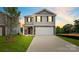 Two-story house with gray siding, stone accents, and a two-car garage at dusk at 1020 20Th Avenue Se Way, Hickory, NC 28602