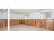 Unfinished basement area with wood paneling and windows at 10414 Club Car Ct, Mint Hill, NC 28227