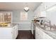 Kitchen with white cabinets, granite counters, and deck access at 10414 Club Car Ct, Mint Hill, NC 28227