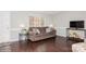 Living room with brown sofa and dark hardwood floors at 10414 Club Car Ct, Mint Hill, NC 28227