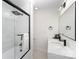 Modern bathroom with double vanity, shower, and frameless glass enclosure at 110 Hubbard St, Belmont, NC 28012