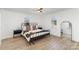 Bright bedroom with wood floors, a metal bed frame, and barn door at 110 Hubbard St, Belmont, NC 28012