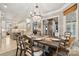 Elegant dining room features a large wooden table, chandelier, and views into the kitchen and sunroom at 1101 Churchill Downs Dr, Waxhaw, NC 28173