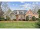 Brick home with stone accents and a manicured lawn at 1101 Churchill Downs Dr, Waxhaw, NC 28173