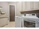 Laundry room with washer, dryer, cabinets, and sink at 1101 Churchill Downs Dr, Waxhaw, NC 28173