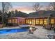 Expansive pool and spa with patio furniture at sunset at 1101 Churchill Downs Dr, Waxhaw, NC 28173