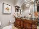 Upscale powder room with ornate vanity, granite countertop, and decorative mirror at 1101 Churchill Downs Dr, Waxhaw, NC 28173