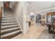 Impressive staircase with dark wood and white risers, offering a view of the kitchen and dining area at 1101 Churchill Downs Dr, Waxhaw, NC 28173