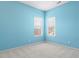 Light blue bedroom with two windows and white carpet at 11104 Fox Cove Dr, Charlotte, NC 28273