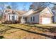 Brick ranch house with a two-car garage and landscaping at 11104 Fox Cove Dr, Charlotte, NC 28273