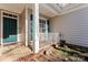 Charming front porch with white railing and green door at 11104 Fox Cove Dr, Charlotte, NC 28273