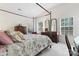 Main bedroom with a four-poster bed and ample closet space at 11104 Fox Cove Dr, Charlotte, NC 28273