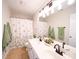 Bright bathroom with double sinks, decorative mirror, and a shower-tub combo at 1120 Spicewood Pines Rd, Fort Mill, SC 29708