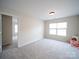 A carpeted bedroom features ample space, natural light, and neutral-colored walls at 1120 Spicewood Pines Rd, Fort Mill, SC 29708