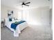 Bright primary bedroom featuring a plush bed, ample natural light, and a ceiling fan at 1120 Spicewood Pines Rd, Fort Mill, SC 29708