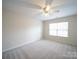 A spacious bedroom with neutral walls, carpet flooring, and a ceiling fan at 1120 Spicewood Pines Rd, Fort Mill, SC 29708