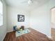 Cozy bedroom with wood flooring, a ceiling fan, and a cheerful dinosaur rug at 1120 Spicewood Pines Rd, Fort Mill, SC 29708