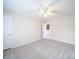 Spacious carpeted bedroom featuring a ceiling fan and a large window at 1120 Spicewood Pines Rd, Fort Mill, SC 29708