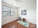 Bright bedroom with wood flooring, ceiling fan, and a large window providing ample natural light at 1120 Spicewood Pines Rd, Fort Mill, SC 29708