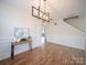 Bright dining room with wood floors, wainscoting, modern light fixture, and an open floor plan at 1120 Spicewood Pines Rd, Fort Mill, SC 29708