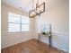 Bright dining room with hardwood floors, wainscoting, and a modern chandelier at 1120 Spicewood Pines Rd, Fort Mill, SC 29708