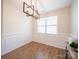 Well-lit dining area featuring wood floors, wainscoting, and a modern chandelier at 1120 Spicewood Pines Rd, Fort Mill, SC 29708