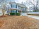 Two-story house with stone and siding accents, a two-car garage, and a landscaped yard at 1120 Spicewood Pines Rd, Fort Mill, SC 29708