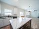 Kitchen featuring an island with marble countertops, stainless steel appliances and white cabinetry at 1120 Spicewood Pines Rd, Fort Mill, SC 29708