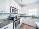 Kitchen features stainless steel appliances, subway tile backsplash and granite countertops at 1120 Spicewood Pines Rd, Fort Mill, SC 29708