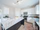 Modern kitchen with white cabinets, subway tile backsplash and an island with marble countertop at 1120 Spicewood Pines Rd, Fort Mill, SC 29708