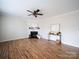 Spacious living room with a fireplace, wood floors, a ceiling fan and neutral walls at 1120 Spicewood Pines Rd, Fort Mill, SC 29708