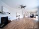 Bright living room featuring a fireplace, wood floors, and seamless open-concept design into the kitchen at 1120 Spicewood Pines Rd, Fort Mill, SC 29708