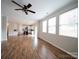 Open floor plan with kitchen island overlooking the living room with fireplace and a ceiling fan at 1120 Spicewood Pines Rd, Fort Mill, SC 29708