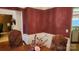 Formal dining room with wood floors and burgundy walls at 113 Rocky Trail Ct, Fort Mill, SC 29715