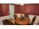 Classic dining room with a wood table, four chairs, and burgundy colored walls at 113 Rocky Trail Ct, Fort Mill, SC 29715