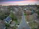 Aerial view of the neighborhood showcases tree-lined streets and the home's prime location near the city skyline at 1136 Bolling Rd, Charlotte, NC 28207