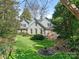 Lush backyard with mature trees, manicured lawn, and a patio area; perfect for outdoor enjoyment at 1136 Bolling Rd, Charlotte, NC 28207